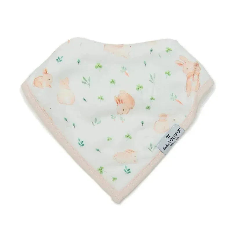 Muslin bib featuring a Bunny Meadow design with soft pastel bunnies and greenery, edged in pink fabric.
