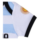 Argentina-themed baby bodysuit featuring light blue and white stripes, with black trim and a sun emblem on the shoulder.