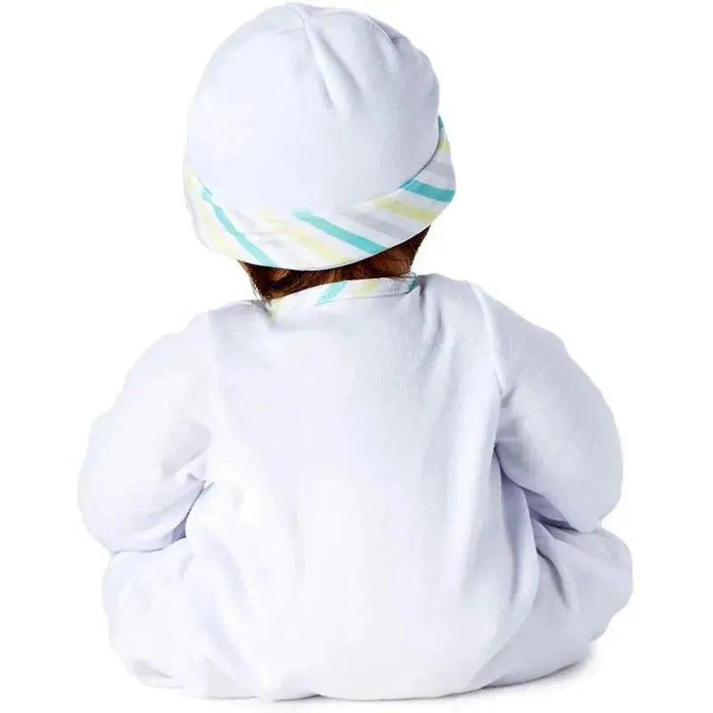 Madame Alexander Baby Face doll with medium skin tone, brown eyes, and black hair, wearing a white outfit and striped hat.