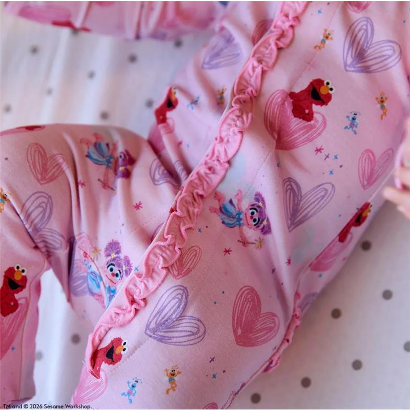 Pink ruffle footie featuring Elmo and friends with heart patterns, designed for infants by Magnetic Me.