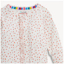 Ruffly convertible coverall by Magnetic Me, featuring a white background with small pink and red apple blossom patterns.