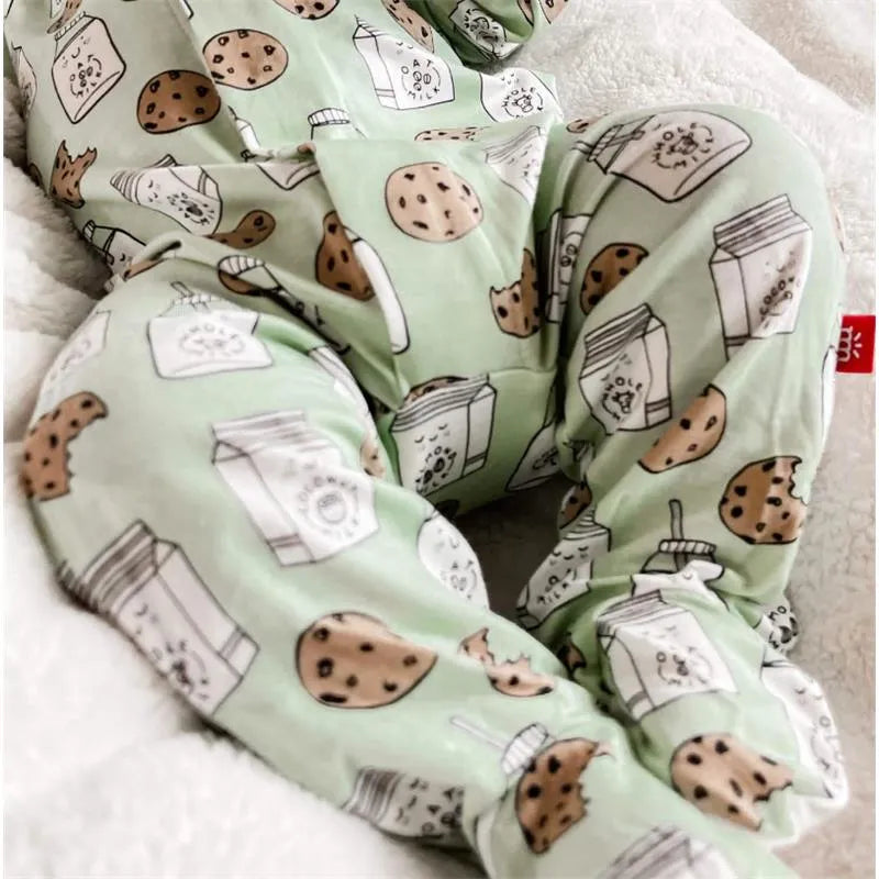 Green baby footie with cookie and milk carton prints, featuring a soft, cozy design for comfortable wear.