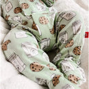 Green baby footie with cookie and milk carton prints, featuring a soft, cozy design for comfortable wear.