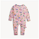 Modal convertible coverall in pink with playful patterns of books, plants, and animals, featuring a front snap closure.