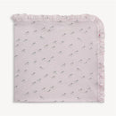 Pink Savannah Plains modal blanket featuring a ruffled edge and a pattern of playful zebras. One size.