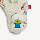 Mod magnetic footie features characters from Toy Story, including Woody and an excited green alien, on a soft, patterned fabric.