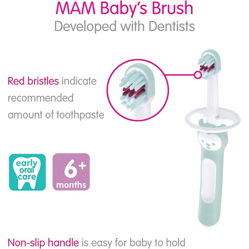 2-pack of MAM baby toothbrushes in pink, designed for 6 months+, featuring a non-slip handle and red bristles to indicate toothpaste amount.