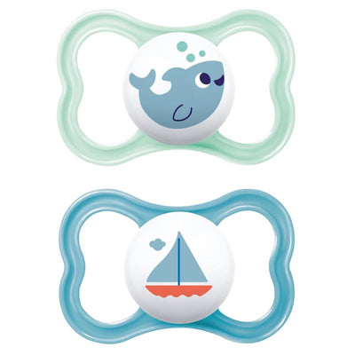 Two Mam pacifiers for boys, featuring a whale and sailboat design, designed for sensitive skin, suitable for ages 6 to 16 months.