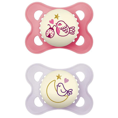 Two silicone pacifiers for girls, one pink with an owl and ladybug design, and one purple with a bird and moon.