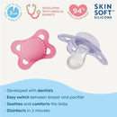 Two MAM Original Matte Baby Pacifiers for girls, one pink and one purple, featuring silicone nipples and self-sterilizing design.