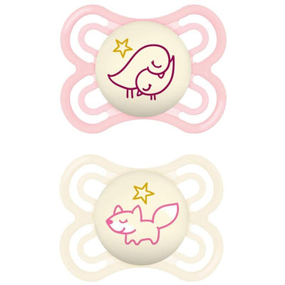 Two baby pacifiers designed for girls, featuring a pink bird and a cream fox on the nipple.
