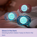 Two MAM baby pacifiers for girls (0-6 months) featuring glowing buttons for easy visibility in the dark, with animal designs.