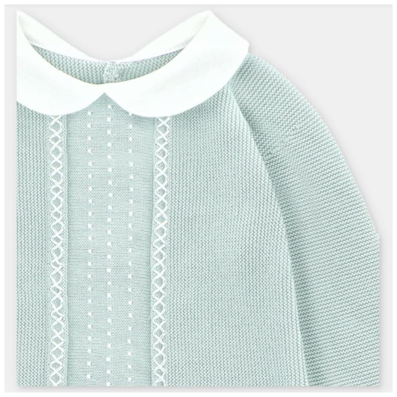 Pastel blue knit sweater with a white collar, featuring textured patterns and decorative details on the front.