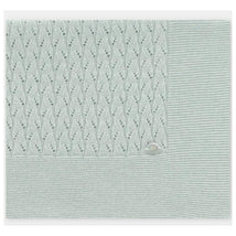 Knit baby blanket in Azul Océano color featuring a textured pattern and a smooth section, ideal for infants.