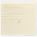 Knit baby blanket in creamy white with textured patterns and a silver label, designed for warmth and comfort.