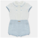 Baby boy set featuring a short-sleeved white shirt with blue trim and matching blue bloomer shorts.