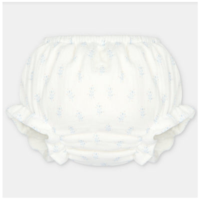 Baby girl bloomer made of woven fabric in white with light blue floral patterns and ruffled edges.