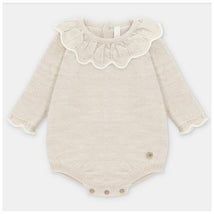 Draylon short knit romper for baby girls in beige, featuring a ruffled collar and button closures at the bottom.
