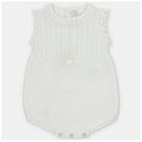 Light pink knitted short romper for baby girls, featuring a ruffled neckline and bow detail on the front.