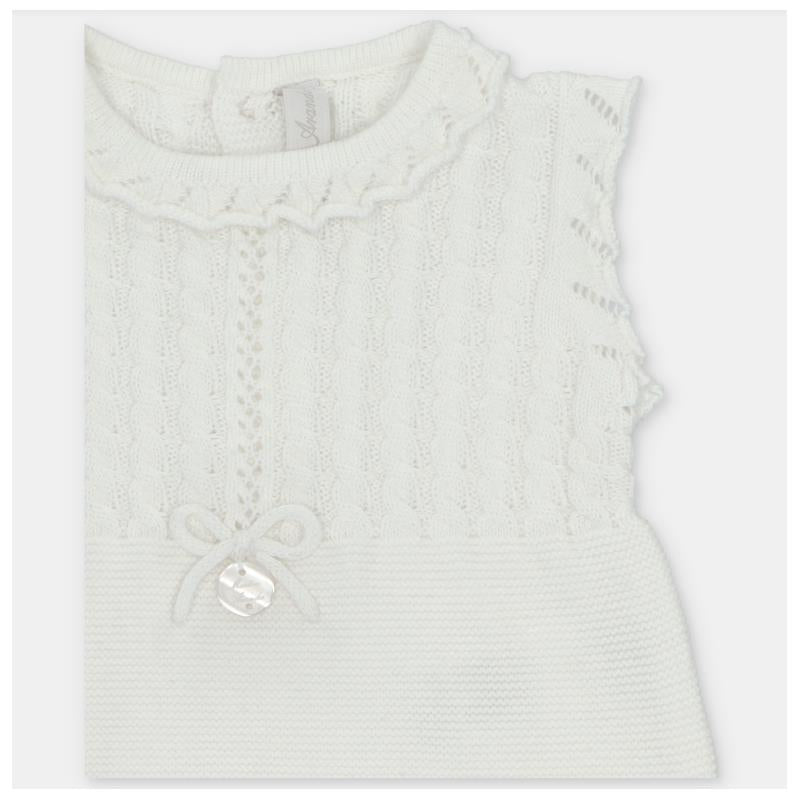 Light pink short romper for baby girls, featuring a textured knit design and a decorative bow on the front.