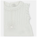 Light pink short romper for baby girls, featuring a textured knit design and a decorative bow on the front.