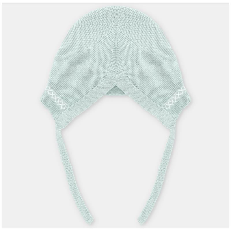 Light pink knitted baby bonnet with ties, featuring a textured design and decorative stitching.