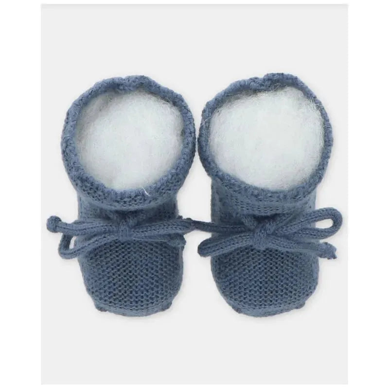 Light blue knitted baby booties with white fluffy lining and tied laces, designed for comfort and style.