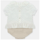 Baby short romper by Martin Aranda featuring a light, polka-dotted top with ruffle sleeves and a knitted beige bottom.