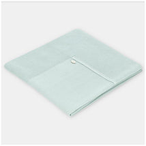 Pastel blue Martin Aranda Blanket Knit Edmonton, folded with a textured edge and a decorative button detail.