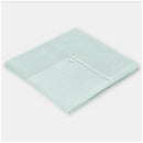 Pastel blue Martin Aranda Blanket Knit Edmonton, folded with a textured edge and a decorative button detail.