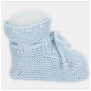 Beige knitted booties with a soft lining and decorative tie, ideal for infants or toddlers.