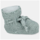 Knit booties in dusty rose with a cozy inner lining, featuring a decorative tie and ribbed cuff.