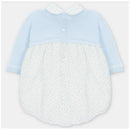 Pastel blue short romper with a knitted top and a woven polka dot bottom, featuring a collar and button closure.
