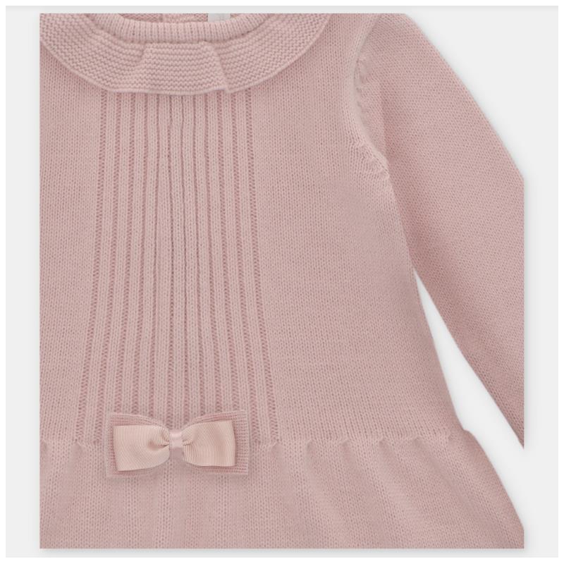 Knitted dusty rose dress featuring ribbed texture and a decorative bow at the waist.