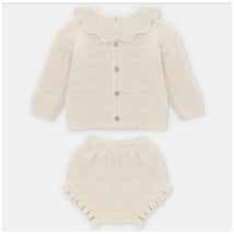 A beige knitwear set for children, featuring a cardigan with a scalloped collar and matching shorts with ruffle trim.