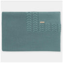 Blue-grey Draylon sweaterknit blanket by Martin Aranda, featuring a textured cable knit design and a small logo tag.