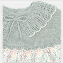 Knitted dress with a light green bodice, decorative collar, and a floral fabric skirt. Perfect for springtime wear.