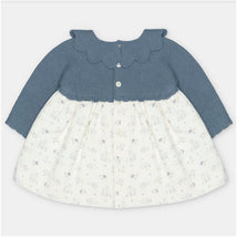 Sweater-knit dress with a blue bodice and white skirt featuring animal patterns and buttons at the front.