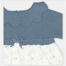 Martin Aranda dress featuring a blue sweater knit top and a floral-patterned fabric skirt with a decorative bow.
