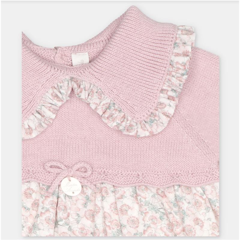 Dress featuring a dusty rose sweater knit bodice with a floral fabric skirt, a ruffled collar, and a decorative bow.