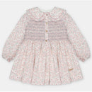 Martin Aranda dress featuring an all-over floral print, smocked bodice, and button detailing, designed for children.