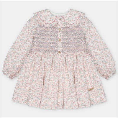 Martin Aranda dress featuring an all-over floral print, smocked bodice, and button detailing, designed for children.