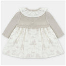 Knit/woven mix dress in Newport and Stone colors, featuring a ruffled collar and button closures on the back.