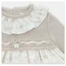 Knit and woven mix dress in Newport stone featuring a ruffled neck, button detail, and a patterned skirt section.