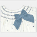 Set dress and bloomer featuring a white woven fabric with blue polka dots and a large blue bow at the neckline.