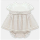 Beige linen dress with short sleeves, tiered skirt, and bloomers, featuring delicate lace and textured details.