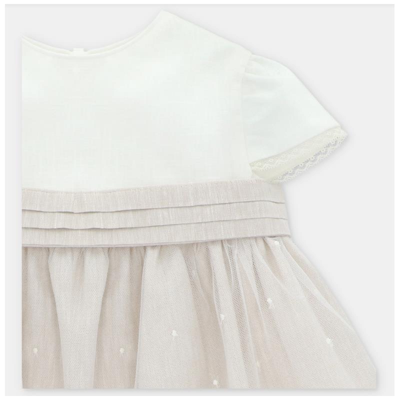 Beige linen dress with a white top and layered tulle skirt, featuring delicate embroidery details.