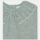 Light green sweater featuring a textured crochet collar and a bow tie at the neck, part of the Martin Aranda set.