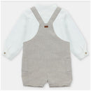 White long-sleeve shirt paired with beige overall shorts featuring two side pockets and adjustable straps.