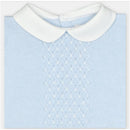 Light blue knitted sweater with a white collar, featuring a textured diamond pattern on the front.